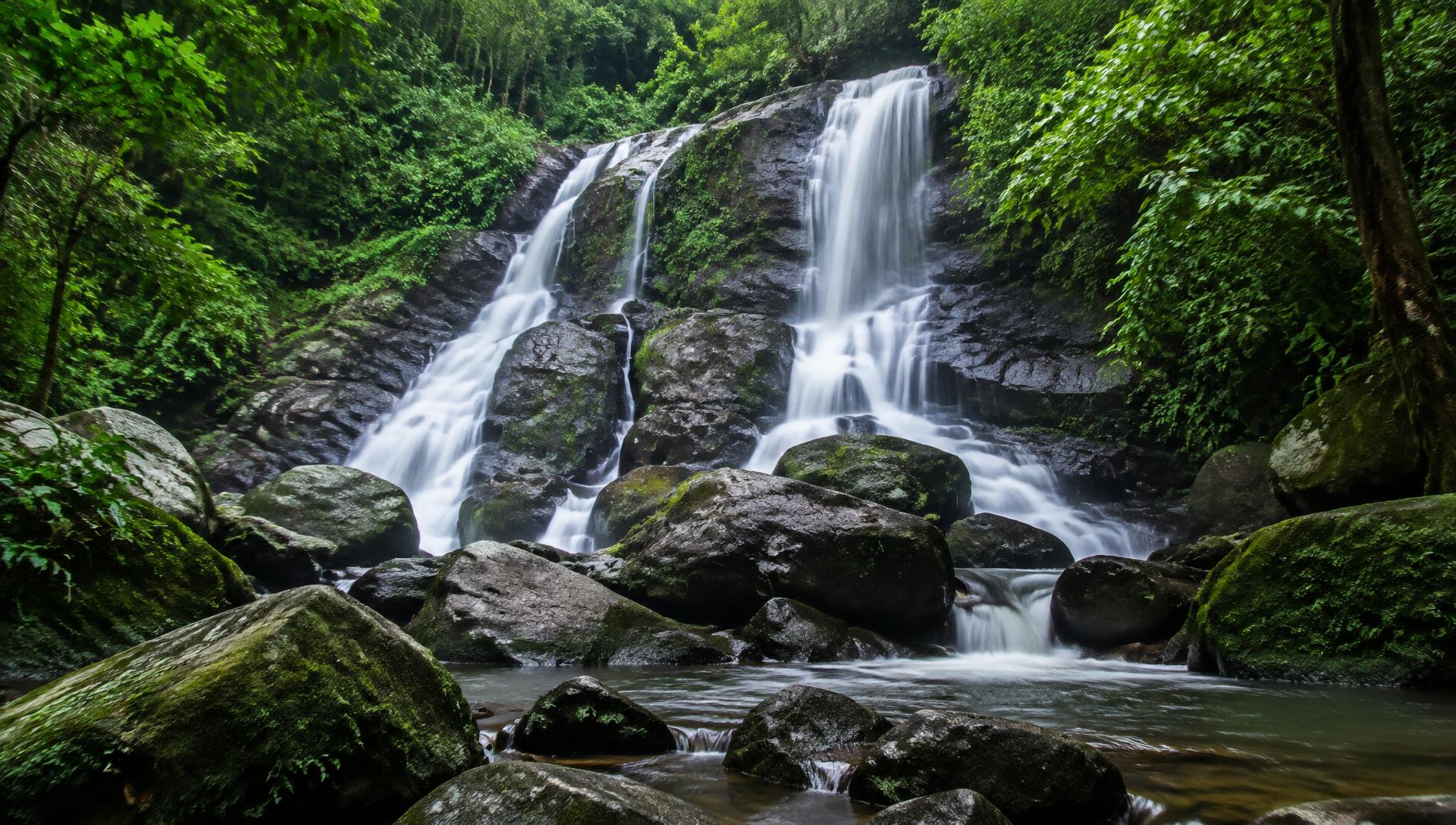 Forest waterfall cascading over mossy rocks near Maredumilli